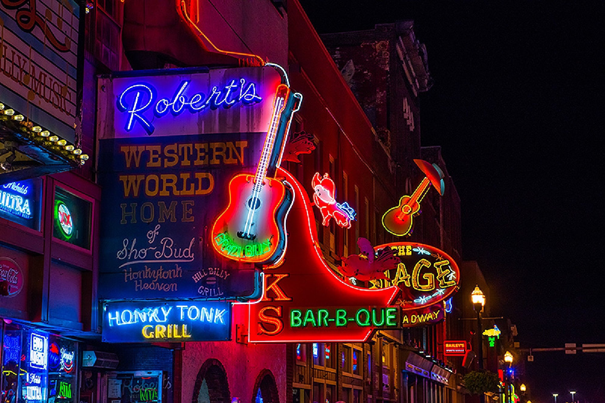 Famous honky-tonks light up the night on Broadway.