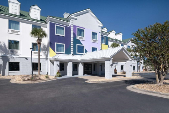 The hotel's exterior and main entrance provide easy access and a warm welcome for guests.