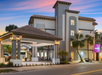 Hotel exterior at dusk.