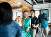 Guests laughing and enjoying cocktails while sitting on bar height chairs with the bar to their left on the Spirit of Norfolk Signature Brunch Cruise.