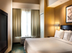 One king bed with plush bedding inside a non-smoking room.