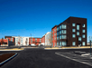 The white, black, and red exterior of the SpringHill Suites by Marriott on a sunny day in Columbus, Ohio.