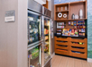 A small market area with refrigerated drinks on the left and shelves stocked with snacks on the right.
