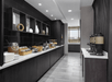A hotel buffet area with black cabinets, white countertop, and various breakfast items. Coffee dispensers line the right side, and decorative items are on the left shelves.