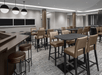 Spacious dining area with high tables and chairs, modern lighting, and a neutral color palette.