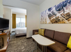 Relax and unwind with a cozy king bed, comfortable seating area, sofa, and TV.