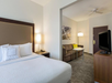 Relax and unwind with a king bed, cozy seating area, sofa, and TV.