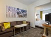 Enjoy a comfortable stay with a king bed, sofa, seating area, and entertainment on the TV.