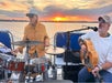 Live music performances against a beautiful sunset backdrop.