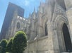 The light gray stone exterior on the St. Patrick's Cathedral on a bright sunny day in New York City.
