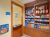 Hotel snack shop with shelves displaying various candies, snacks, and sundries. A "Team Members Only" door is on the left.