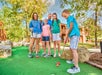Guests playing miniature golf.