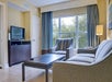 Living room with a flat-screen TV and sofa bed.