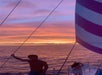 Two people on the boat watching the sunset in Waikiki, Hawaii.