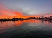 The sun setting in the distance while on the ocean in Waikiki, Hawaii.