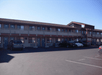 Hotel exterior and parking space.