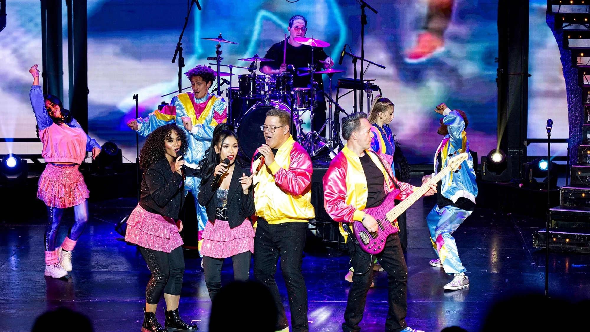 Colorful retro fashion and upbeat choreography by The Jets.
