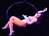 Performing on a hoop, is a lady at the Teatro Martini Dinner Comedy Theatre