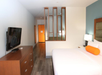 One king bed inside a guest room.