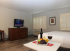 One king bed and dining area inside a guest room.