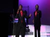 Two men in red and black suits singing into microphones on stage at The Best of Motown and More in Branson, Missouri.