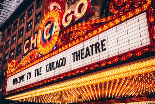 Marquee of the Chicago Theatre with bright lights and signage reading "Welcome to the Chicago Theatre.