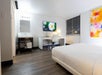 Guest room featuring one king bed, a convenient work desk, and a flat-screen TV.
