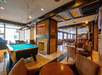 A pool table inside a restaurant on property.