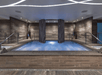 An indoor hot tub with gray stone around it and stairs leading up on both sides at the Sahra Spa Salon & Hammam.