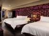 Two queen beds inside a guest room.