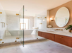 Spacious bathroom with a freestanding bathtub, walk-in, glass-enclosed shower and marble finishes