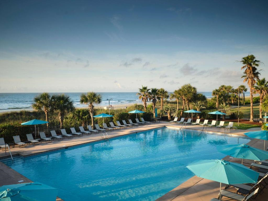 Take a refreshing dip in the oceanfront outdoor pool with sun loungers and umbrellas.