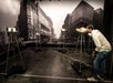 A man in a white shirt observes telescopes mounted on stands. A large black-and-white cityscape mural is in the background.