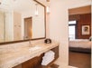 Private bathroom with sink, mirror, and fresh towels.