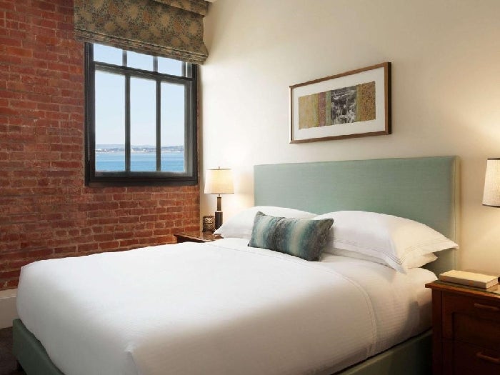 One king bed and bedside lamps inside a guest room.