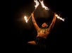 A man Fire Dancing and yelling at night at The Feast at Mokapu Luau in Wailea, Hawaii, USA.