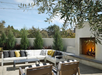 Relaxing outdoor patio with daybeds and fireplace.