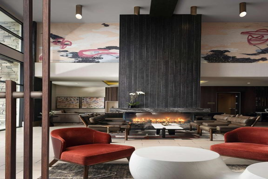 Cozy lobby with seating area and fireplace.