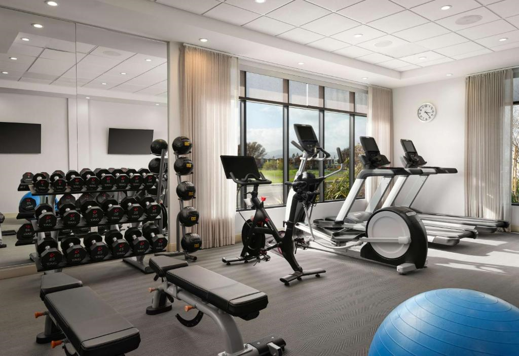 Fitness center treadmills, elliptical trainer, free weights, and other gym equipment.