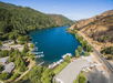 Aerial view of the deep blue water of the Blue Lakes on a bright sunny day with the mountains in the distance.