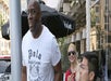 A tall man in a white t-shirt walking with a blonde woman in sun glasses and a man in glasses standing next to him on the Paparazzi Safari.