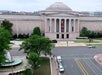 Aerial view of the National Gallery of Art, Washington D.C., showcasing its neoclassical facade with a large dome, surrounded by trees, and adjacent streets with minimal traffic.