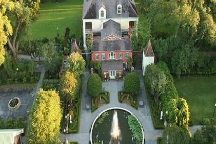 Aerial view looking down on the Houmas House Plantation and Gardens on a sunny day.
