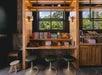 A sitting area decorated with modern yet vintage feel decor with books, games and other activities at with a small window above it.