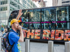 The rapper performs in a New York alley while the guests on the bus cheer him on.