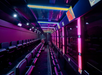 The beautiful bus interior of The Ride with neon lights.