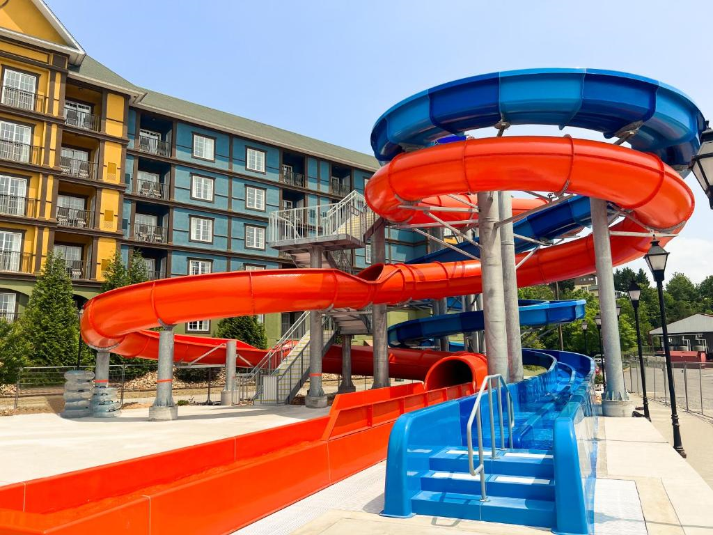 Outdoor pool with water slides, lazy river, and children's play area.