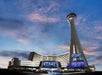View looking up at The STRAT Hotel, Casino and SkyPod  at dusk with a blue and purple sky in Las Vegas, Nevada.