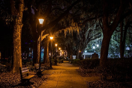 Savannah’s haunted parks and mossy oaks seen on a nighttime trolley ghost tour.