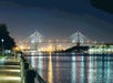 Savannah's Talmadge Memorial Bridge glowing over the river at night.
